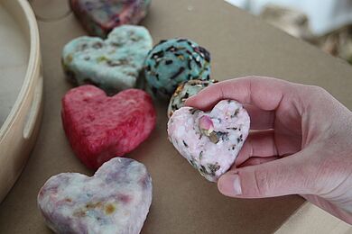 Eine Person zeigt die handgemachte Seife, die in der Elsterkammer verkauft wird